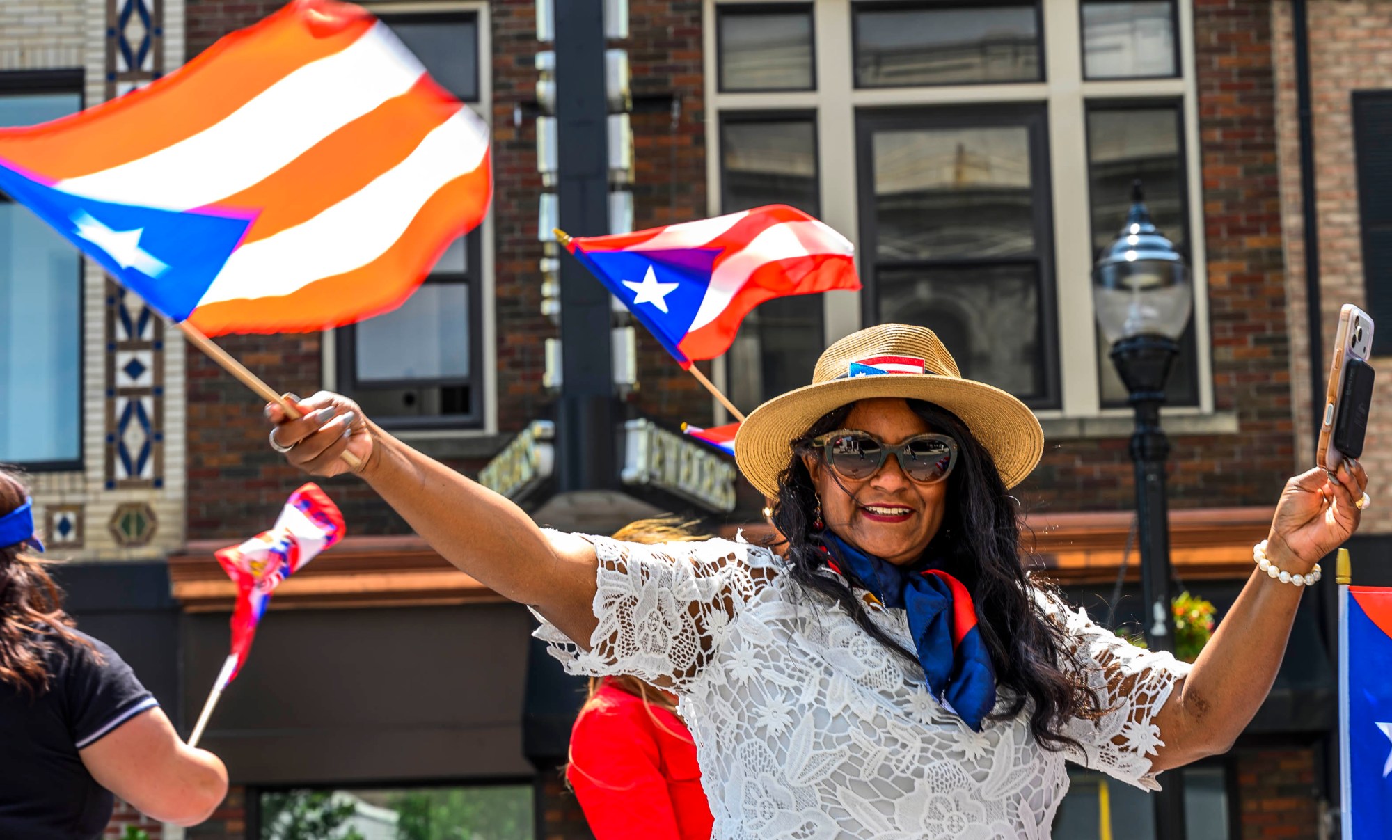 Allentown Council Vice President Cynthia Mota waves a Puerto Rican flag during the annual Lehigh Valley Puerto Rican Day Parade and Festival on Sunday, July 19, 2026, in Allentown. The day's festivities were sponsored by Puertorrican Cultural Preservation. (April Gamiz/The Morning Call)