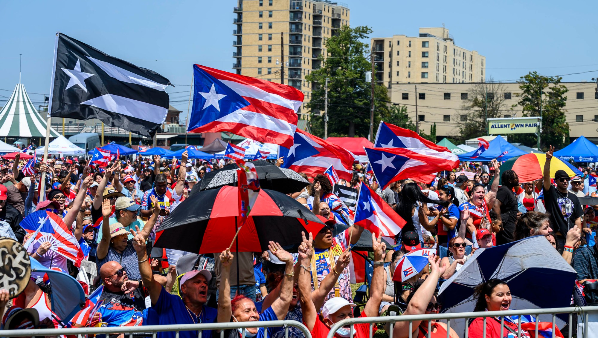 People celebrate during the annual Lehigh Valley Puerto Rican Day Festival on Sunday, July 19, 2026, at the Allentown Fairgrounds. The day's festivities, sponsored by Puertorrican Cultural Preservation, also included raising the Puerto Rican flag and a parade. (April Gamiz/The Morning Call)