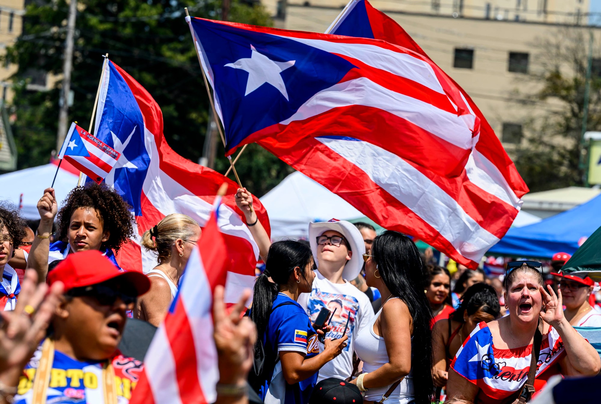 People celebrate during the annual Lehigh Valley Puerto Rican Day Festival on Sunday, July 19, 2026, at the Allentown Fairgrounds. The day's festivities, sponsored by Puertorrican Cultural Preservation, also included raising the Puerto Rican flag and a parade. (April Gamiz/The Morning Call)
