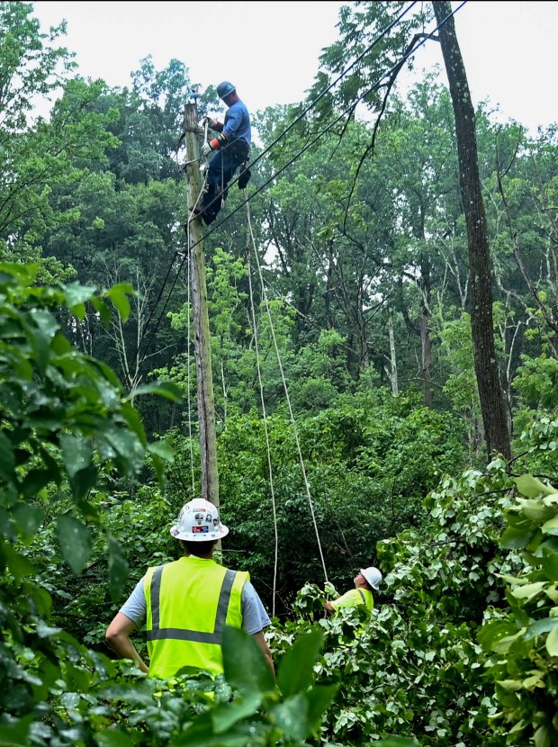 Workers repair damaged power lines Tuesday, July 7, 2026, near Victory Valley Camp in Upper Milford Township. Storms that hit the Lehigh Valley over the weekend caused road closures and electricity outages throughout the region. Utilities said it could take until Thursday to fully restore power. (Jon Chiu/The Morning Call)