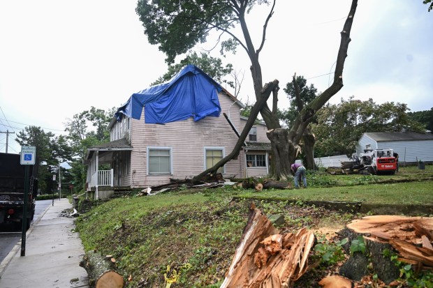 Workers clear storm damage Tuesday, July 7, 2026, in Alburtis. Storms that hit the Lehigh Valley over the weekend caused road closures and electricity outages throughout the region. Utilities said it could take until Thursday to fully restore power. (Jon Chiu/The Morning Call)