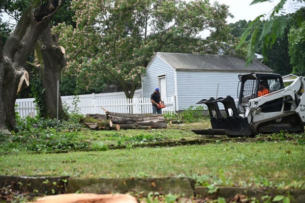 Workers clear storm damage Tuesday, July 7, 2026, in Alburtis. Storms that hit the Lehigh Valley over the weekend caused road closures and electricity outages throughout the region. Utilities said it could take until Thursday to fully restore power. (Jon Chiu/The Morning Call)