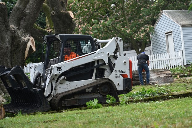 Workers clear storm damage Tuesday, July 7, 2026, in Alburtis. Storms that hit the Lehigh Valley over the weekend caused road closures and electricity outages throughout the region. Utilities said it could take until Thursday to fully restore power. (Jon Chiu/The Morning Call)