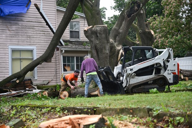 Workers clear storm damage Tuesday, July 7, 2026, in Alburtis. Storms that hit the Lehigh Valley over the weekend caused road closures and electricity outages throughout the region. Utilities said it could take until Thursday to fully restore power. (Jon Chiu/The Morning Call)