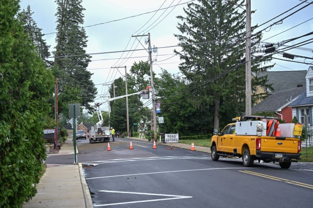Workers repair damaged power lines Tuesday, July 7, 2026, in Alburtis. Storms that hit the Lehigh Valley over the weekend caused road closures and electricity outages throughout the region. Utilities said it could take until Thursday to fully restore power. (Jon Chiu/The Morning Call)
