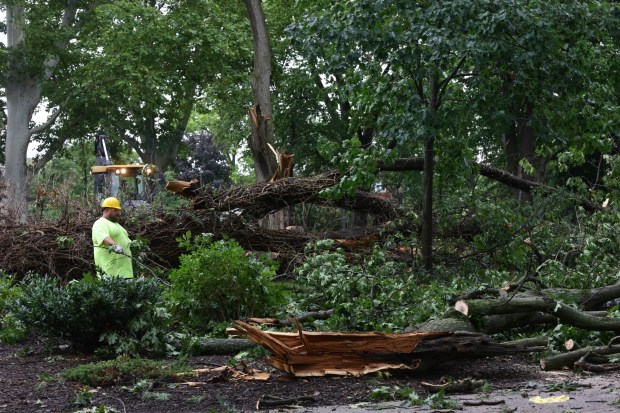 City workers clean fallen trees, limbs and debris Monday, July 6, 2026, at West Park in Allentown. Storms that hit the Lehigh Valley over the weekend caused damage in the park, as well as road closures and power outages throughout the region. (Monica Cabrera/The Morning Call)