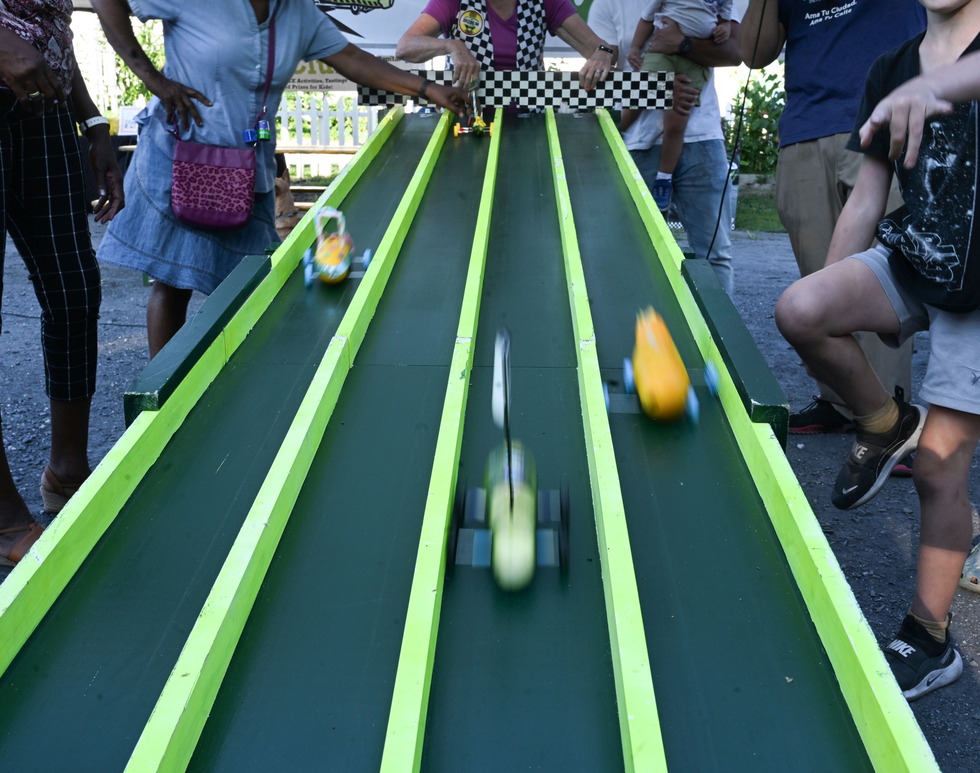 Zucchini cars race down the track during the 20th Annual Zucchini 500 on Thursday, July 23, 2026 at the 10th & Pine street community garden in Easton. According to West Ward Community Initiative manager Jacob Behler, events like the 'Zuke 500' are meant to help foster new community connections and help people have affordable and local access to healthy produce. (Jon Chiu/The Morning Call)