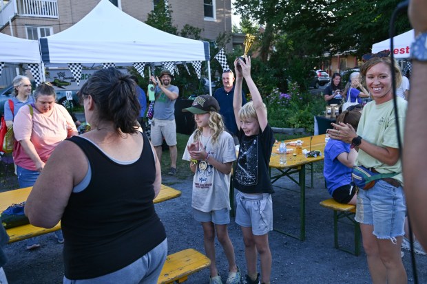 Henry Nees, 8, holds up the trophy for most creative car after he and his sister, Ellie Nees, 10, both won the award during the 20th Annual Zucchini 500 on Thursday, July 23, 2026 at the 10th & Pine street community garden in Easton. Both Neeses had connected their zucchini cars together, causing the judge to award them both. (Jon Chiu/The Morning Call)