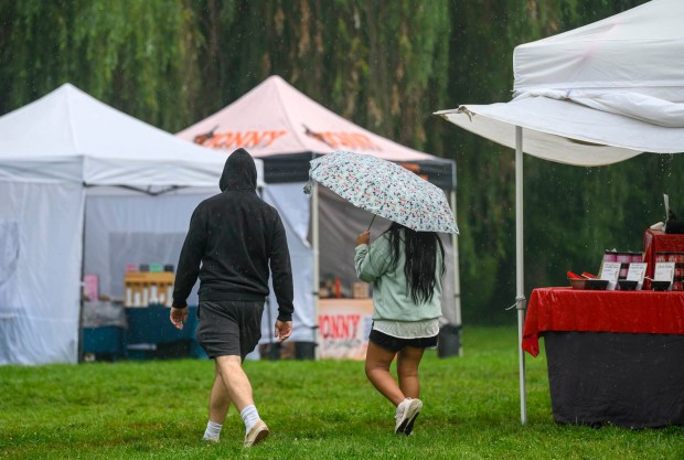 Despite the rain Saturday, July 18, 2026, people attend the Bethlehem Blueberry Festival, organized by Historic Bethlehem Museums & Sites at Burnside Plantation. The festival offers Colonial demonstrations, activities, vendor tents, blueberry-themed foods, and live music.(April Gamiz/The Morning Call)