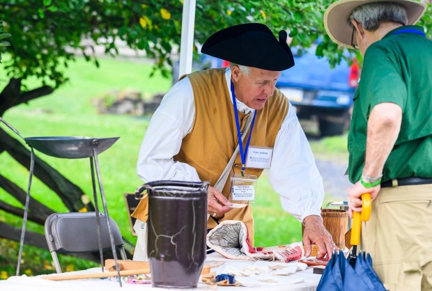 Volunteer Tony Sabino gives a Colonial era demonstration Saturday, July 18, 2026, during Bethlehem Blueberry Festival, organized by Historic Bethlehem Museums & Sites at Burnside Plantation. The festival offers Colonial demonstrations, activities, vendor tents, blueberry-themed foods and live music. (April Gamiz/The Morning Call)