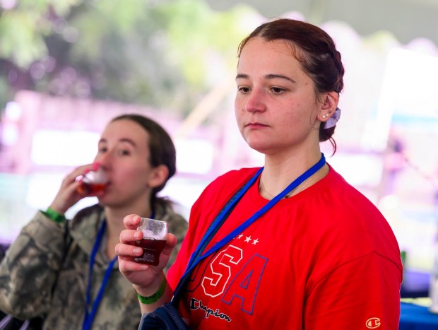 Lexi Ciano, of Easton orders a Christmas City Spirits Blueberry Bounce drink Saturday, July 18, 2026, during Bethlehem Blueberry Festival, organized by Historic Bethlehem Museums & Sites at Burnside Plantation. Christmas City Spirits' Blueberry Bounce is a blueberry-based, spiced liqueur that was popular in Colonial America and said to be a favorite of George Washington. (April Gamiz/The Morning Call)