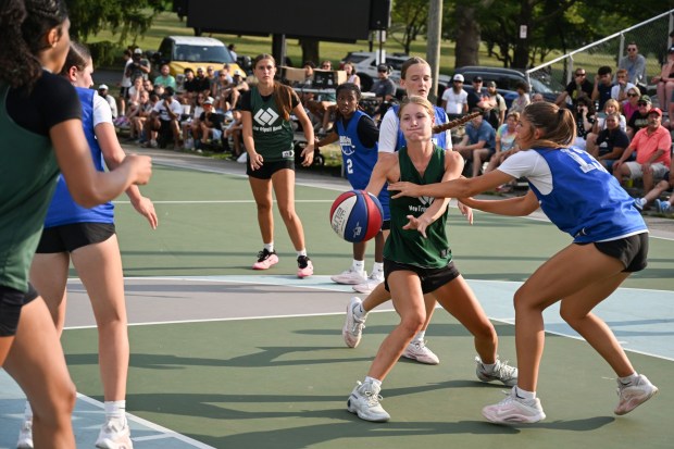 Sophia Shutkufski passes the ball to Gracie Ervin during Emmaus' game against Bensalem during the A-Town Throwdown basketball tournament finals Sunday, July 26, 2026, in Cedar Beach in Allentown. (Jon Chiu/The Morning Call)