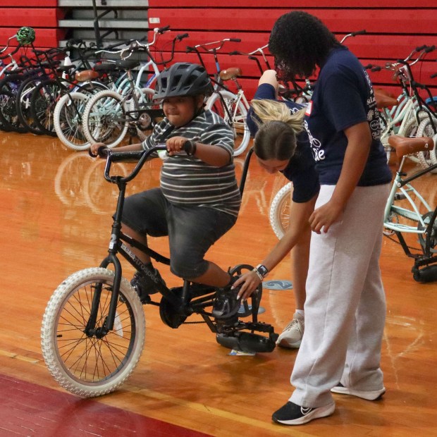 Volunteers from iCanBike help get Xander Hartner of Bethlehem, 17, ready to ride a training bicycle Wednesday, July 29, 2026, at Easton Area High School in Palmer Township. iCanBike will remain at the high school to teach individuals with various disabilities how to ride both training and conventional bicycles until Friday. (Jon Chiu/The Morning Call)