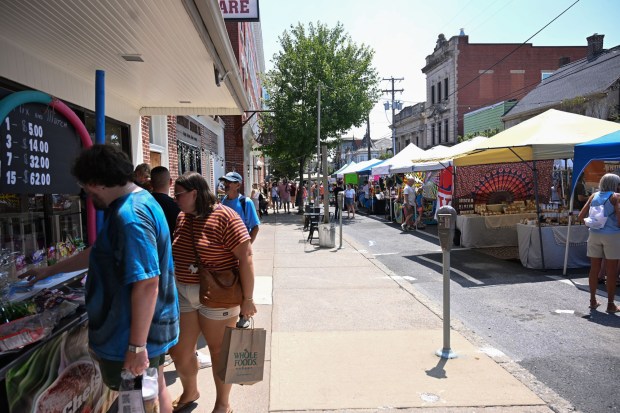 People walk among food trucks and tents during the annual Martin on Main street fair Saturday, July 25, 2026, in Nazareth. (Jon Chiu/The Morning Call)