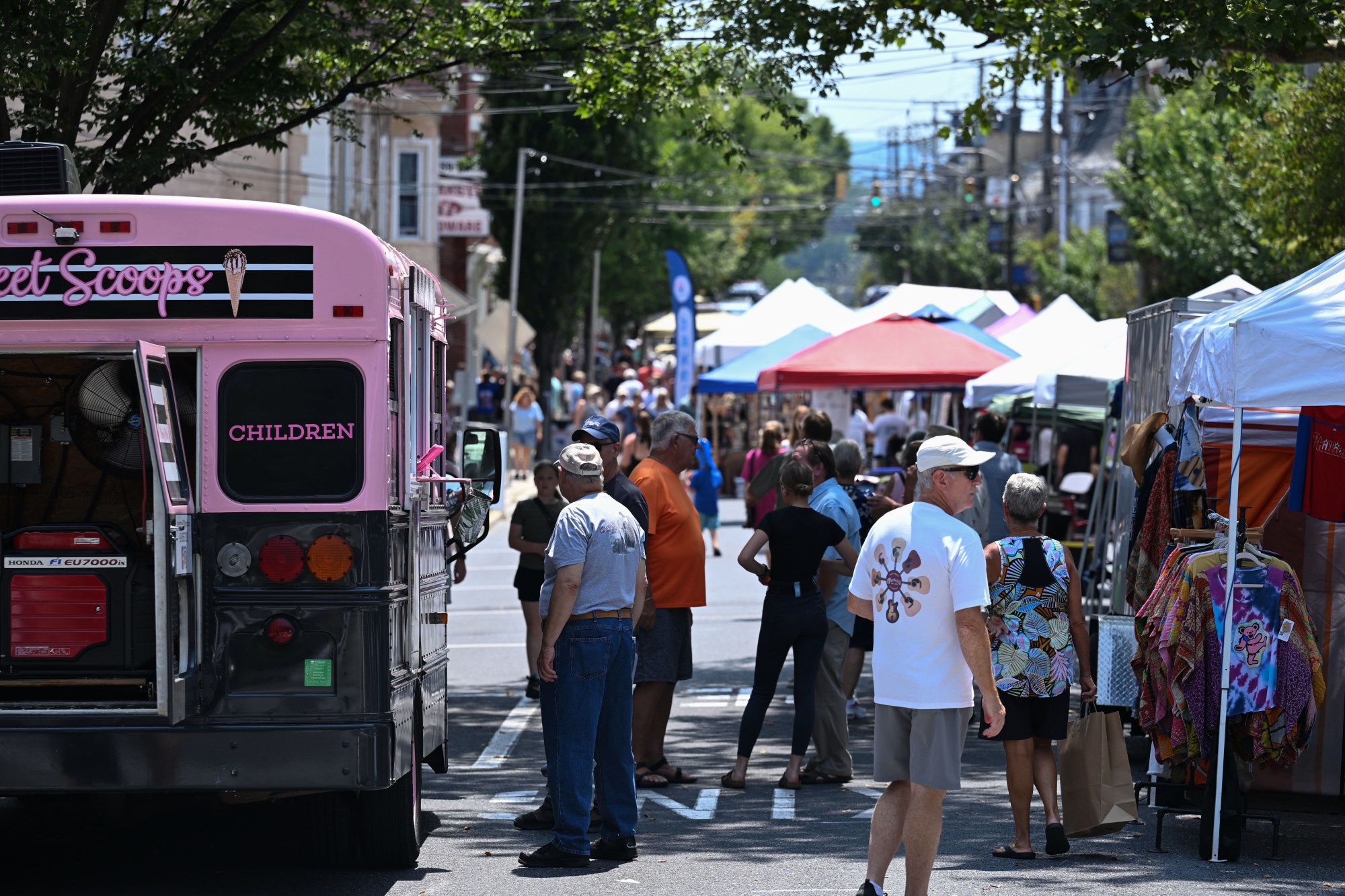 People walk among food trucks and tents during the annual Martin on Main street fair Saturday, July 25, 2026, in Nazareth. (Jon Chiu/The Morning Call)