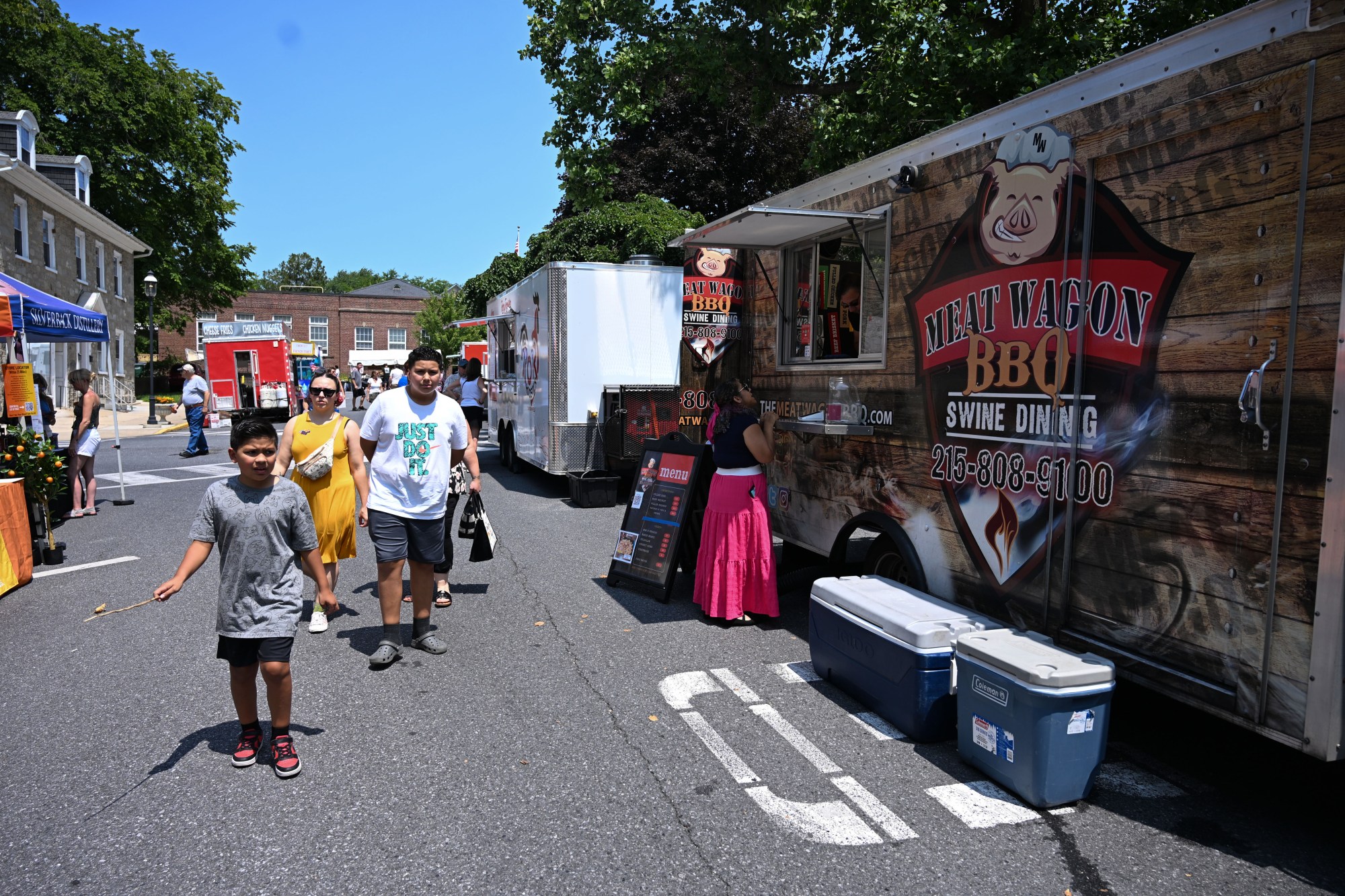 People walk among food trucks and tents during the annual Martin on Main street fair Saturday, July 25, 2026, in Nazareth. (Jon Chiu/The Morning Call)