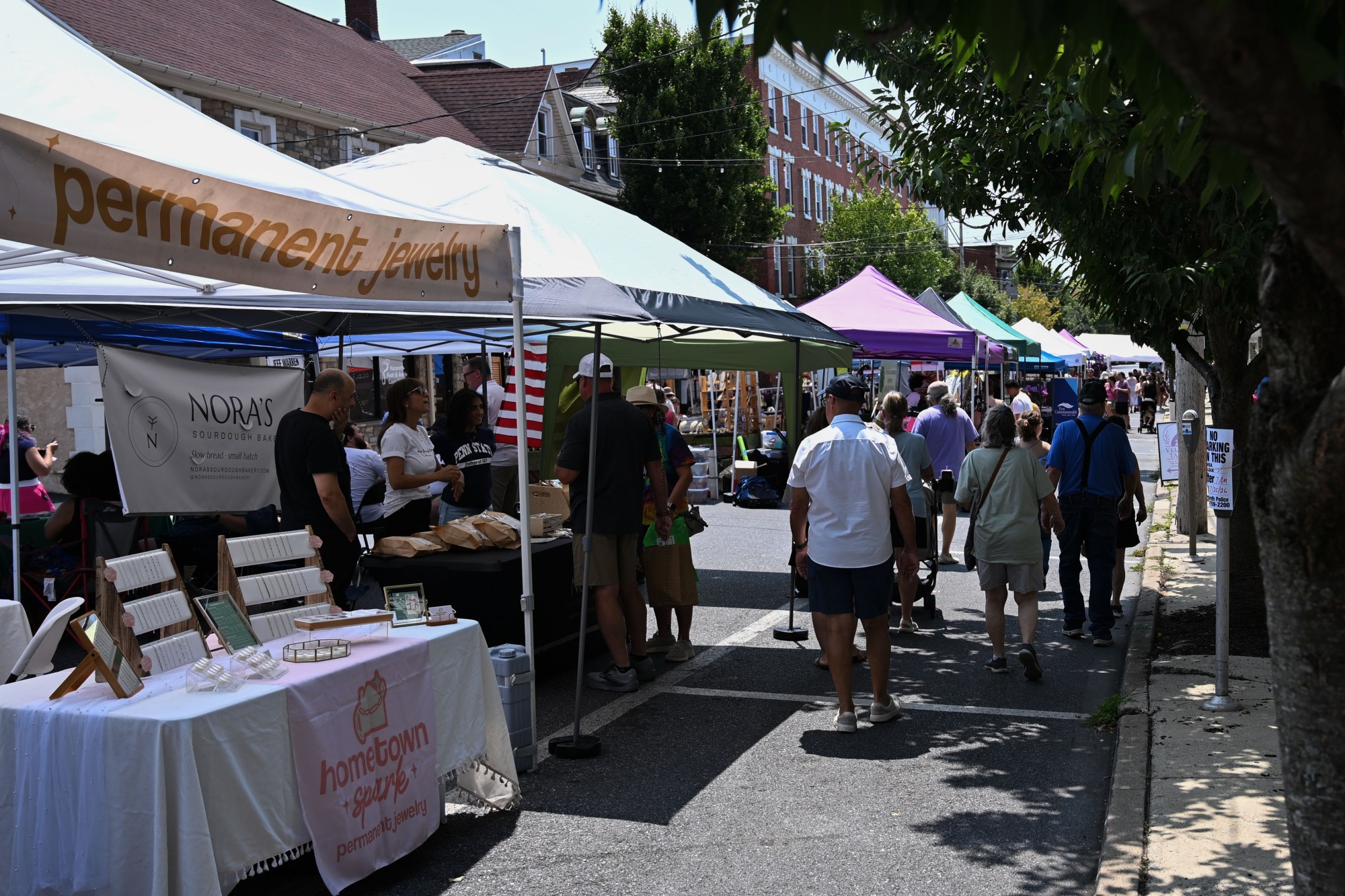 People walk among food trucks and tents during the annual Martin on Main street fair Saturday, July 25, 2026, in Nazareth. (Jon Chiu/The Morning Call)