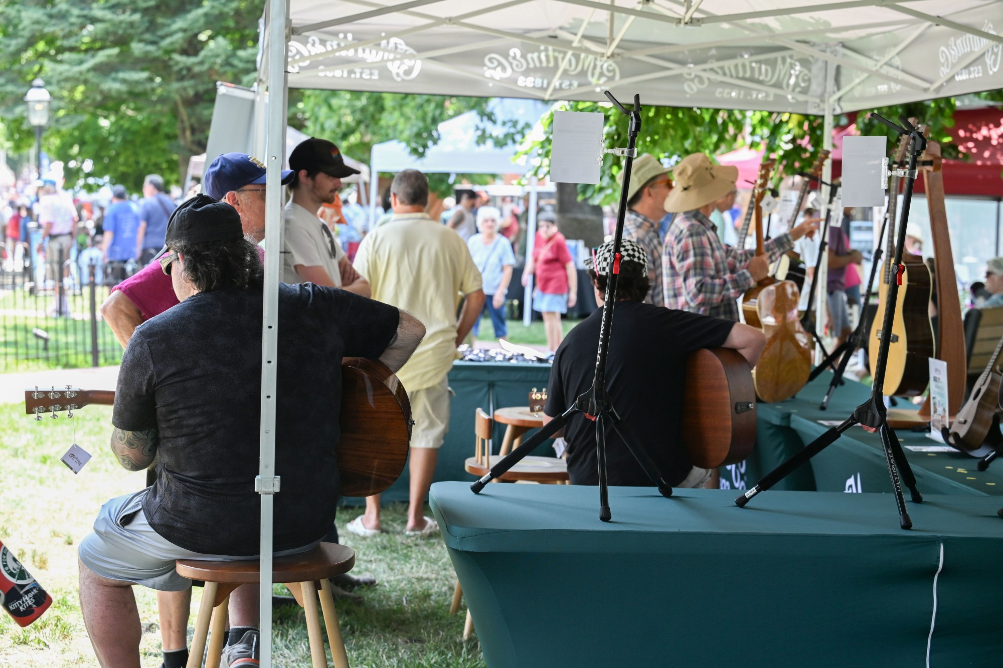 People inspect guitars made by C.F. Martin & Co. during the annual Martin on Main street fair Saturday, July 25, 2026, in Nazareth. (Jon Chiu/The Morning Call)