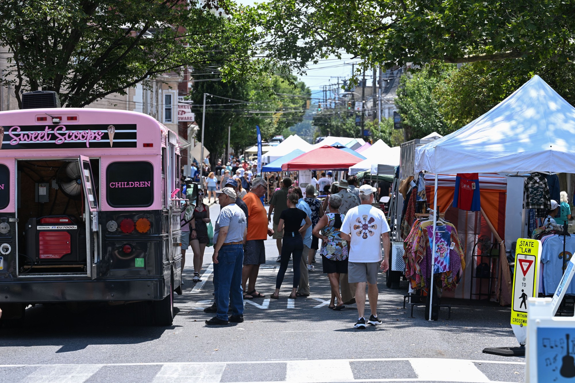 People walk among food trucks and tents during the annual Martin on Main street fair Saturday, July 25, 2026, in Nazareth. (Jon Chiu/The Morning Call)