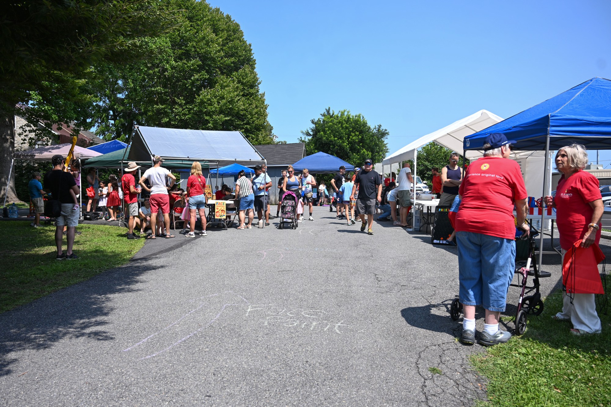 People walk in the kids zone set up during the annual Martin on Main street fair Saturday, July 25, 2026, in Nazareth. (Jon Chiu/The Morning Call)