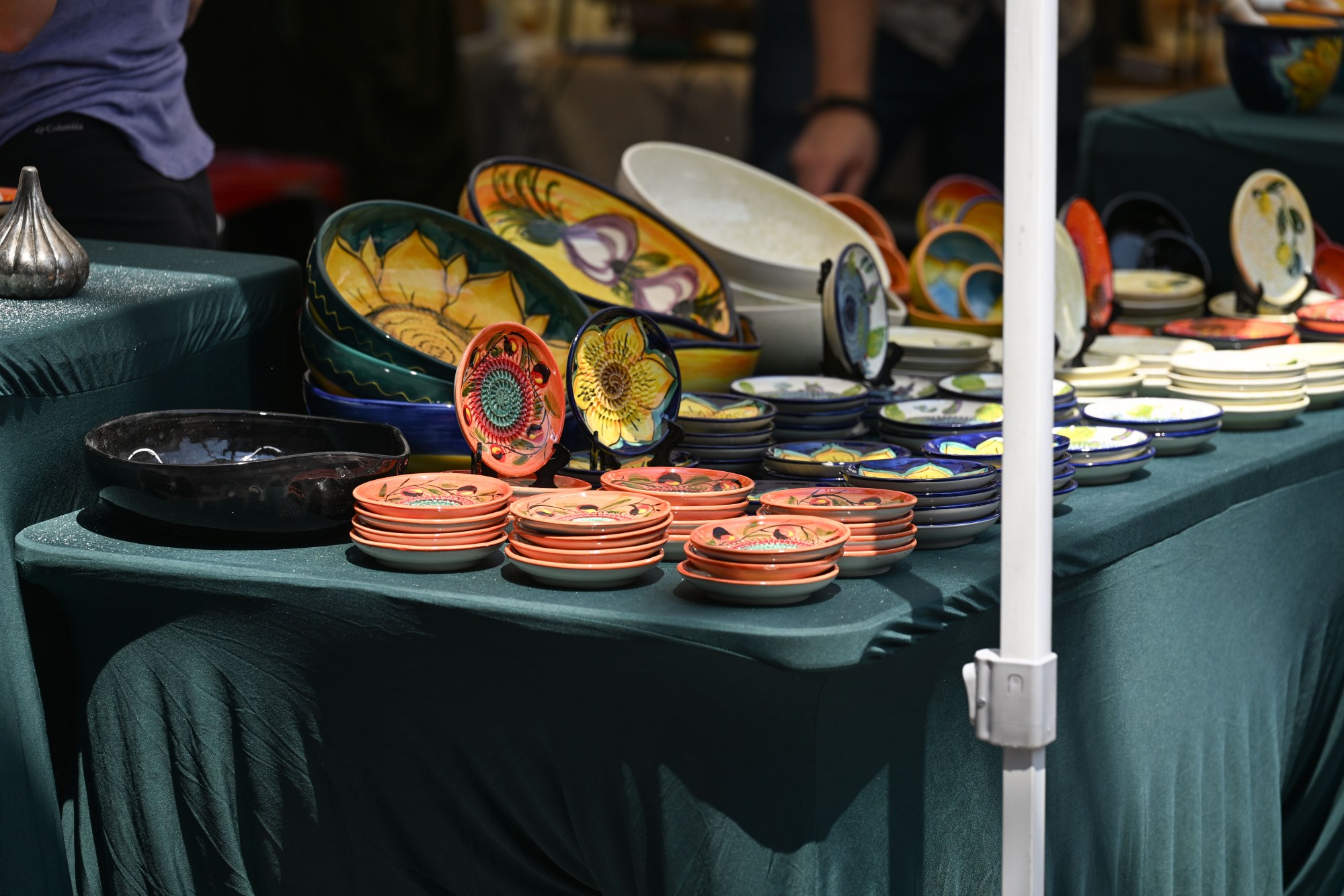 Plates sit stacked on a table for sale during the annual Martin on Main street fair Saturday, July 25, 2026, in Nazareth. (Jon Chiu/The Morning Call)