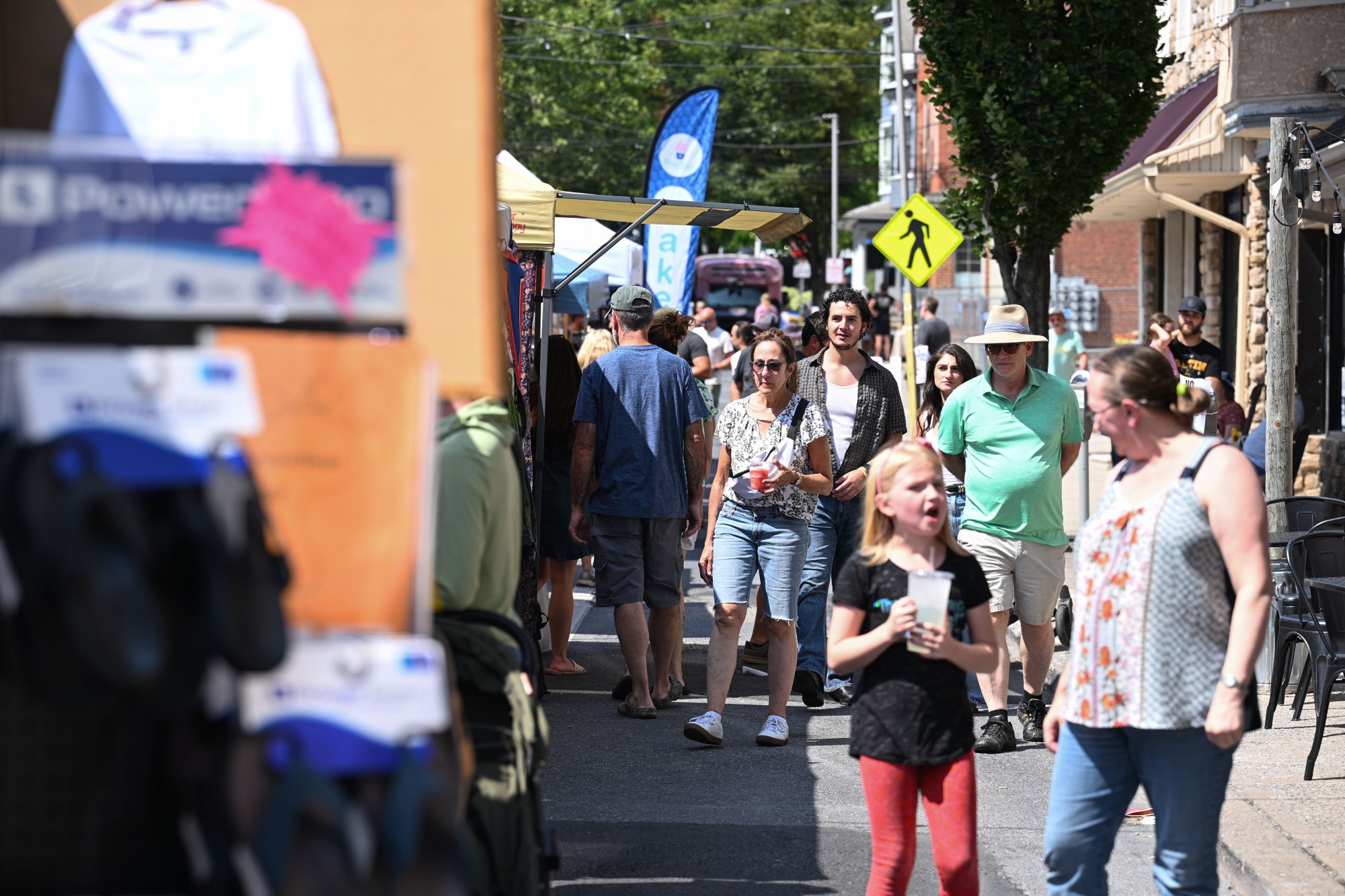 People walk among food trucks and tents during the annual Martin on Main street fair Saturday, July 25, 2026, in Nazareth. (Jon Chiu/The Morning Call)