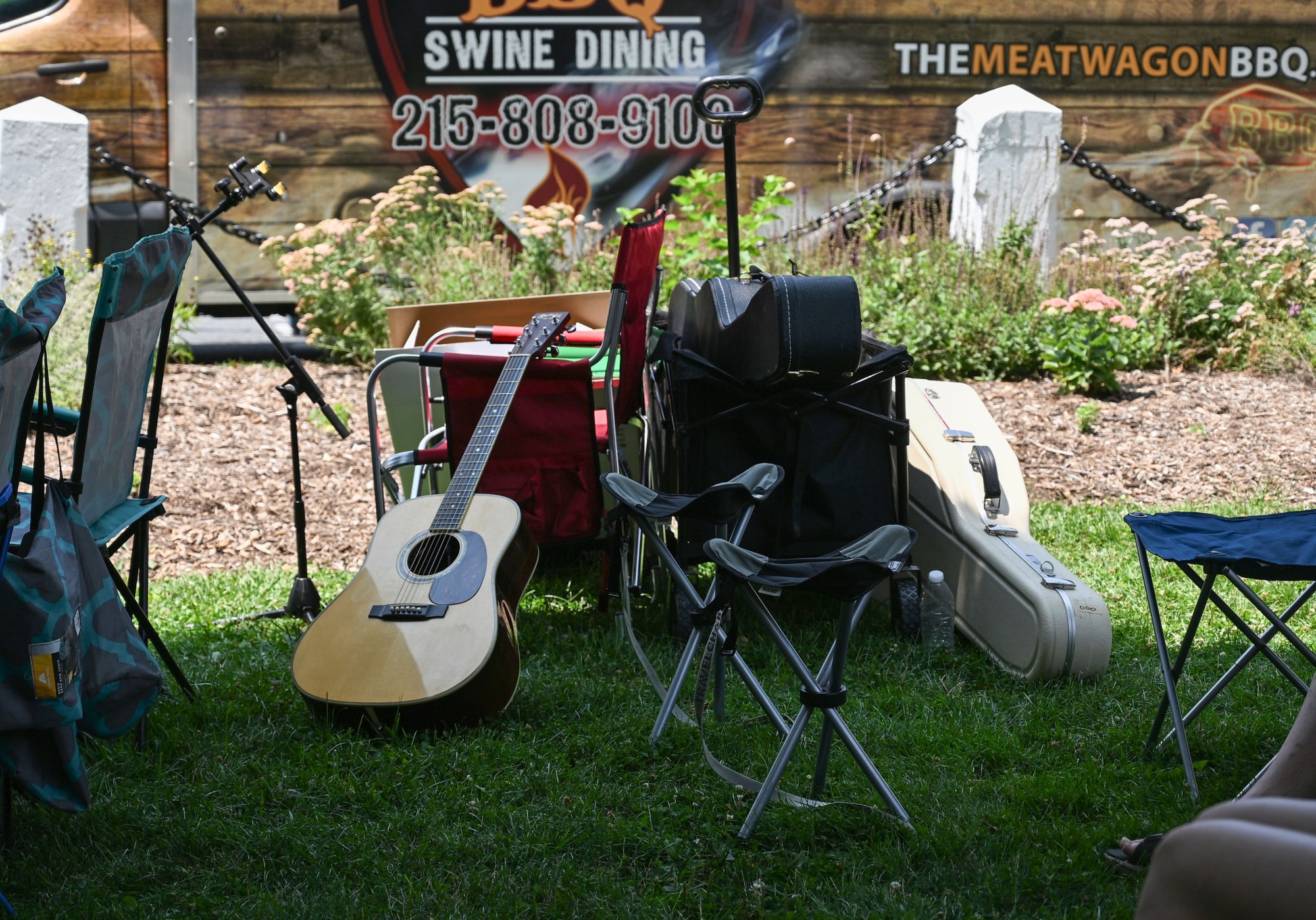 Guitars and guitar cases lie in the grass during the annual Martin on Main street fair Saturday, July 25, 2026, in Nazareth. (Jon Chiu/The Morning Call)