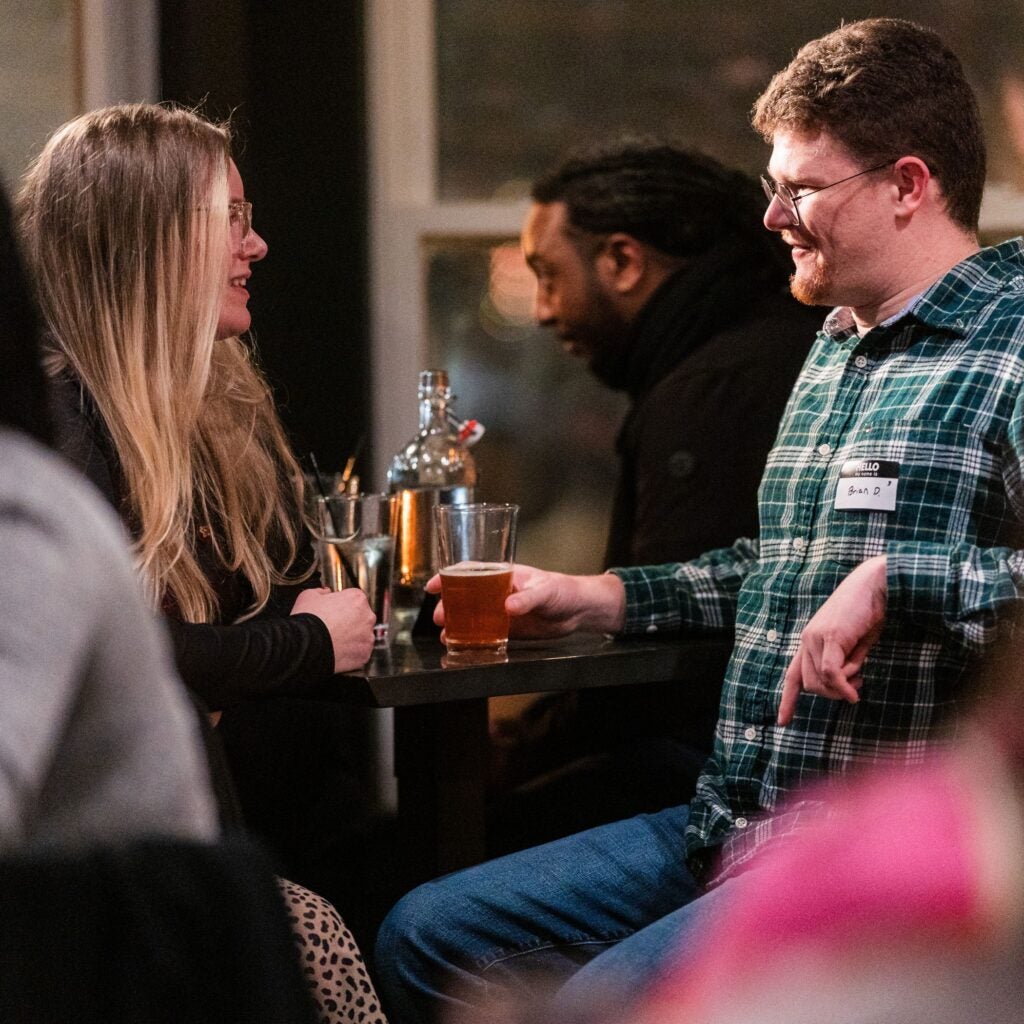 Two event attendees sitting across from one another