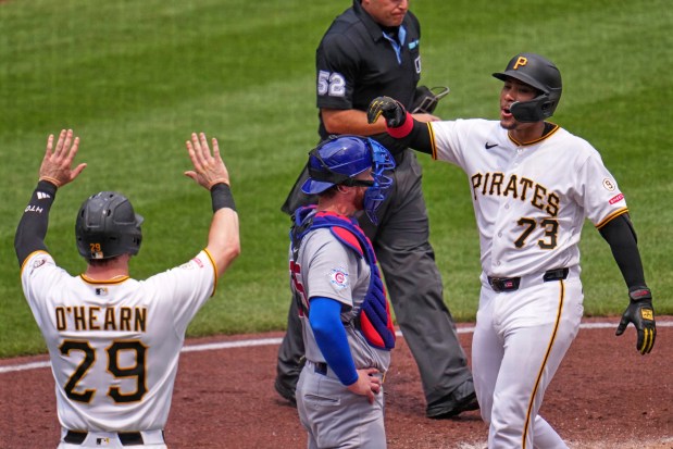 Pittsburgh Pirates' Shawn Ross (73) crosses home plate past Chicago Cubs catcher Carson Kelly, center, and is greeted by Ryan O'Hearn (29) after hitting a two-run home run off Cubs pitcher Jameson Taillon during the second inning of a baseball game in Pittsburgh, Sunday, July 26, 2026. (AP Photo/Gene J. Puskar)