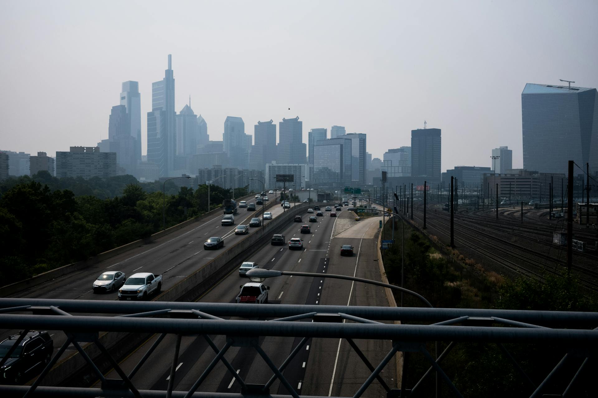 View of smoggy urban skyline in backgorund and highway in foreground