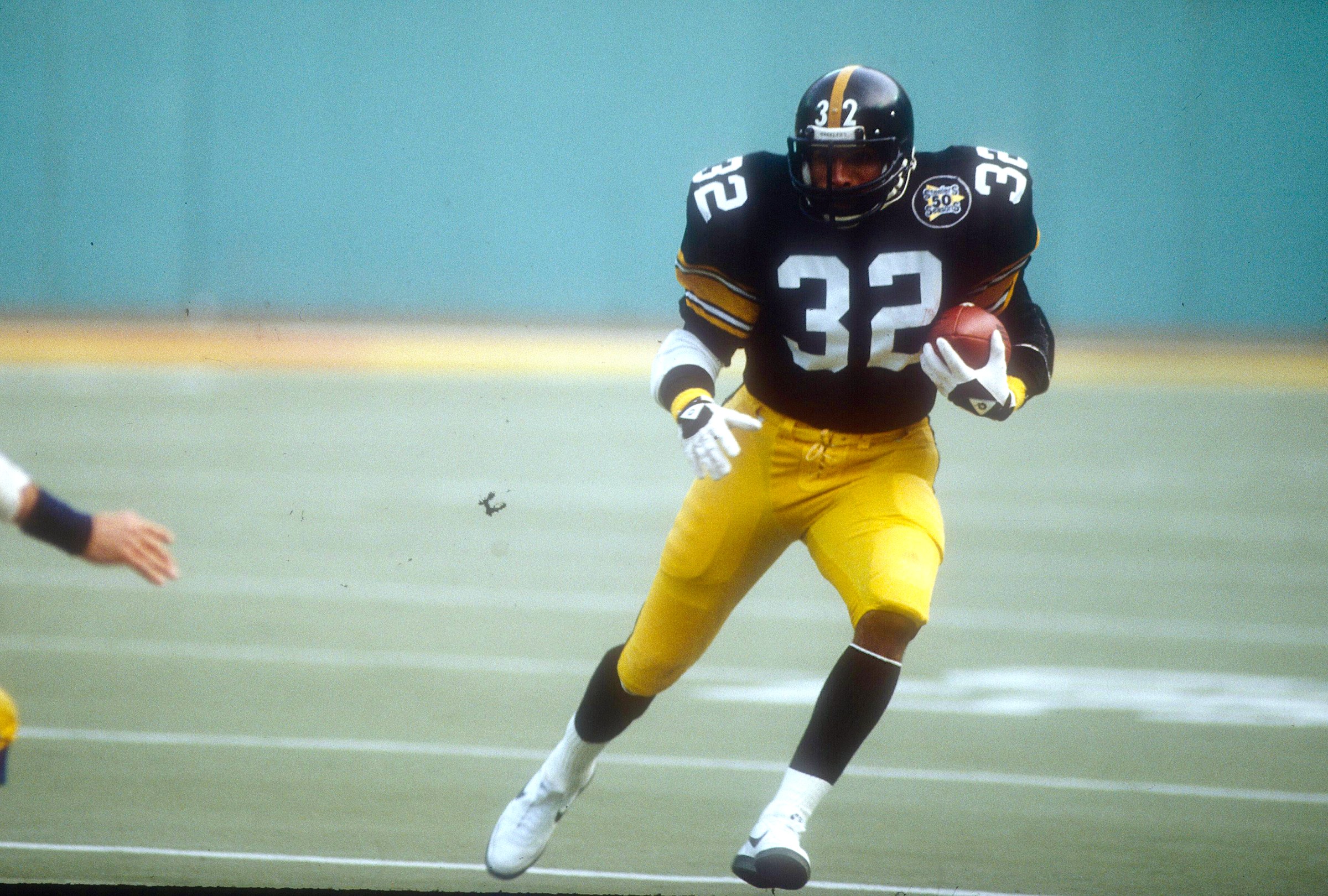 PITTSBURGH, PA - JANUARY 9: Running back Franco Harris #32 of the Pittsburgh Steelers carries the ball against the San Diego Chargers during the NFL/AFC Wild Card Game January 9, 1983 at Three Rivers Stadium in Pittsburgh, Pennsylvania. The Chargers won the game 31-28. Harris played for the Steelers from 1972-83. (Photo by Focus on Sport/Getty Images)