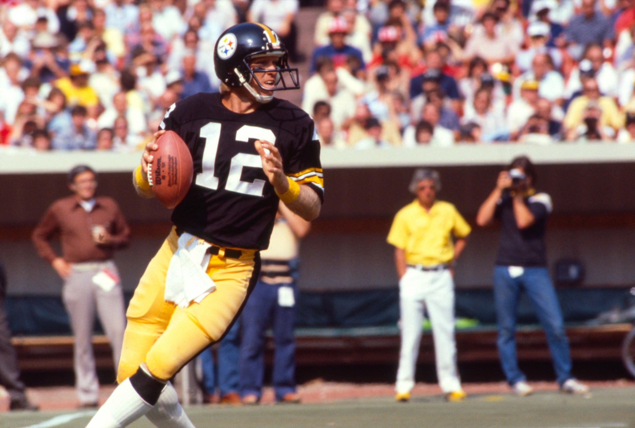PITTSBURGH, PENNSYLVANIA - SEPTEMBER 9: Quarterback Terry Bradshaw #12 of the Pittsburgh Steelers looks to pass during a game against the Houston Oilers on September 9, 1979 at Three Rivers Stadium in Pittsburgh, Pennsylvania. Bradshaw played for the Steelers for his entire NFL career, from 1970-1983, and led the team to four Super Bowl Championships. (Photo by James Drake/Getty Images)