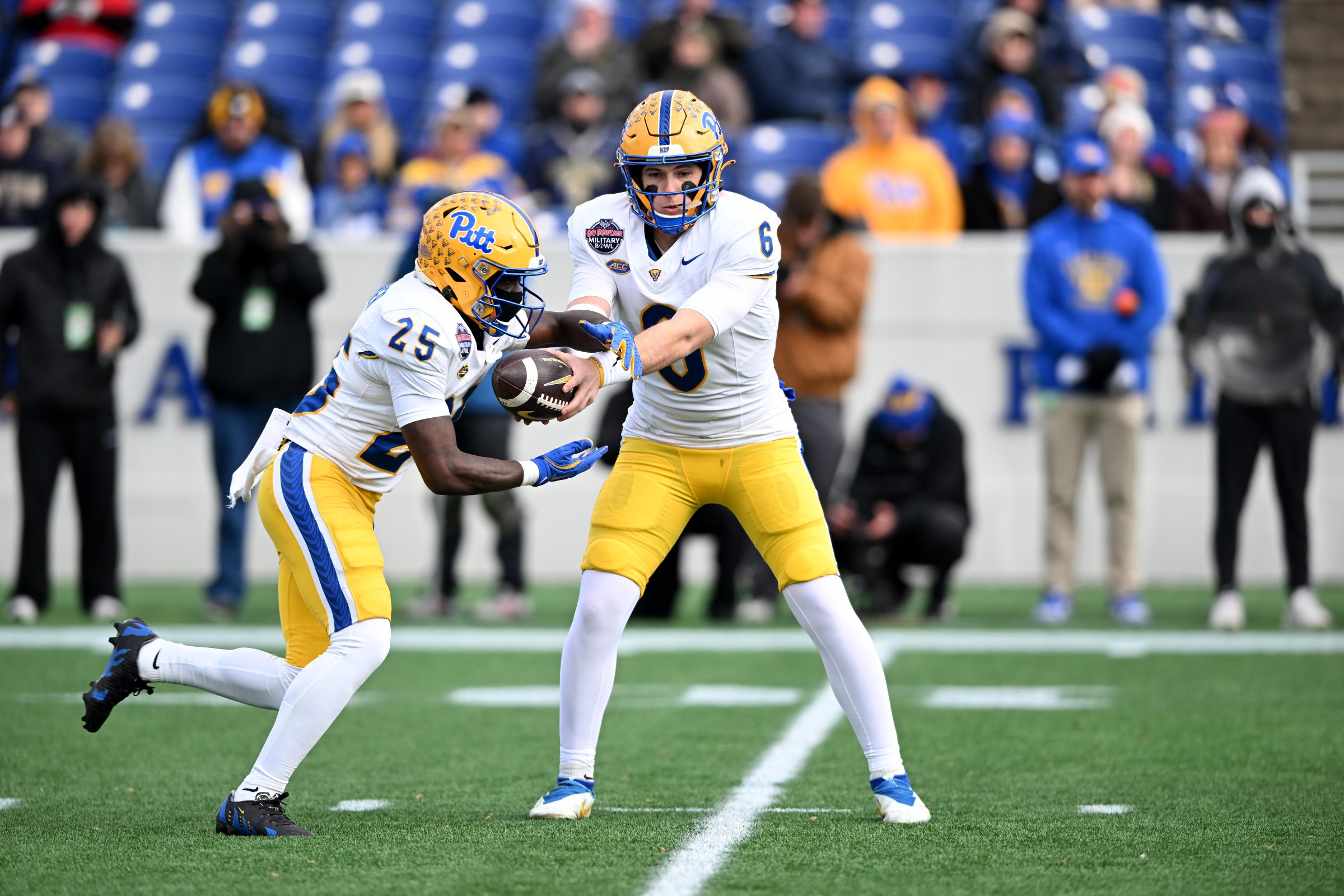 ANNAPOLIS, MARYLAND - DECEMBER 27: Mason Heintschel #6 of the Pittsburgh Panthers hands off the ball to Ja’Kyrian Turner #25 against the East Carolina Pirates during the 2025 Go Bowling Military Bowl at Navy-Marine Corps Memorial Stadium on December 27, 2025 in Annapolis, Maryland. (Photo by G Fiume/Getty Images)