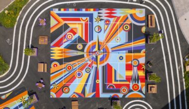 a drone view of two of three pickleball courts in downtown Pittsburgh painted with bright geometric, abstract murals