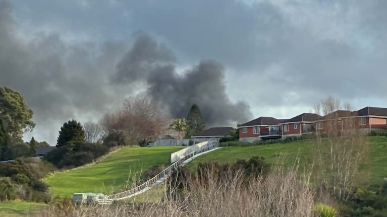 Smoke billows from a house in Bethlehem, Tauranga.