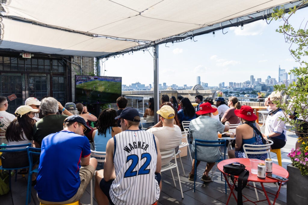 Fans watch the World Cup match at the rooftop bar.