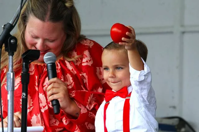 <p>Little Mr. Tomato 2026 Colton Malloy, 3, holds up a small tomato on stage.</p>
<p>Margaret Roarty | Sunday Dispatch</p>
