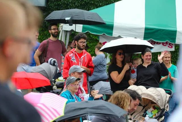 <p>Attendees of the Little Miss and Mr. Tomato pageant watch from the audience under cover of their umbrellas.</p>
<p>Margaret Roarty | Sunday Dispatch</p>