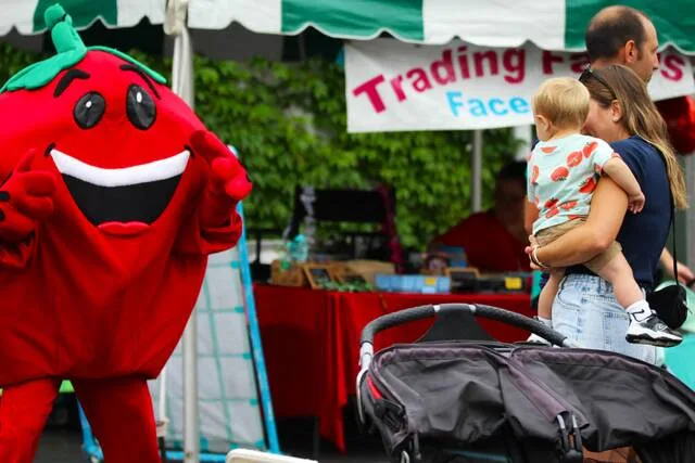 <p>Stewie, the official mascot of the Pittston Tomato Festival, waves hello to a family in the crowd.</p>
<p>Margaret Roarty | Sunday Dispatch</p>