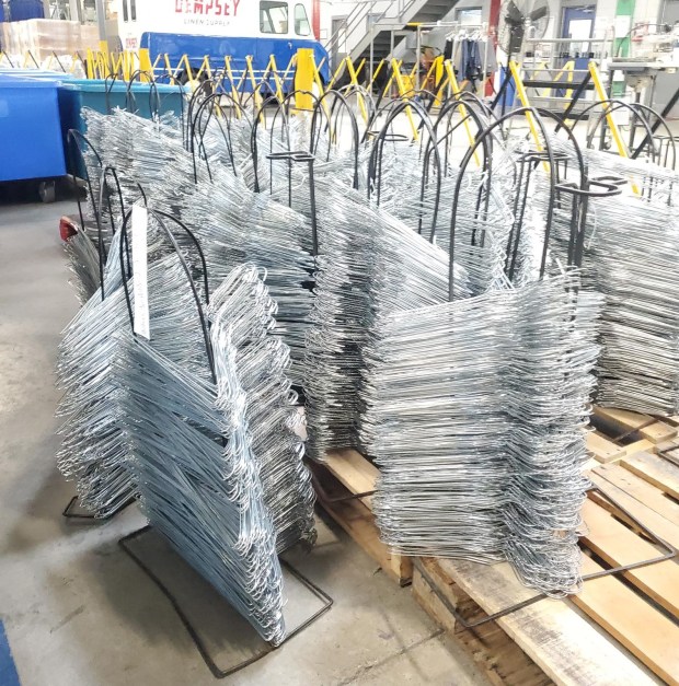 Clients from Allied Services' Vocational Services Division's Work Services Program refurbish hangers for Dempsey's Uniform & Linen Supply in Jessup. (Courtesy Allied Services)