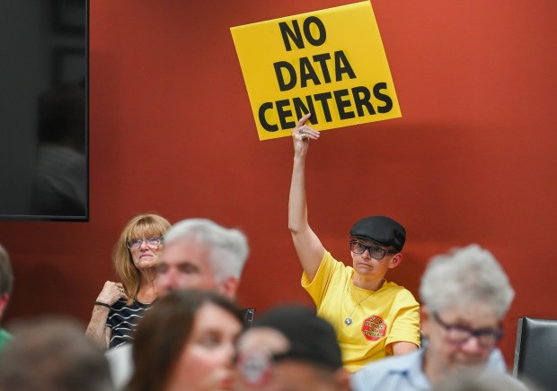 Founder of the Lackawanna Citizens' Overwatch Project Aline Browning holds up a sign that reads '"No Data Centers" during the Lackawanna County Commissioners' Meeting held at the county government center in Scranton Wednesday, August 5, 2026. (SEAN MCKEAG / STAFF PHOTOGRAPHER)