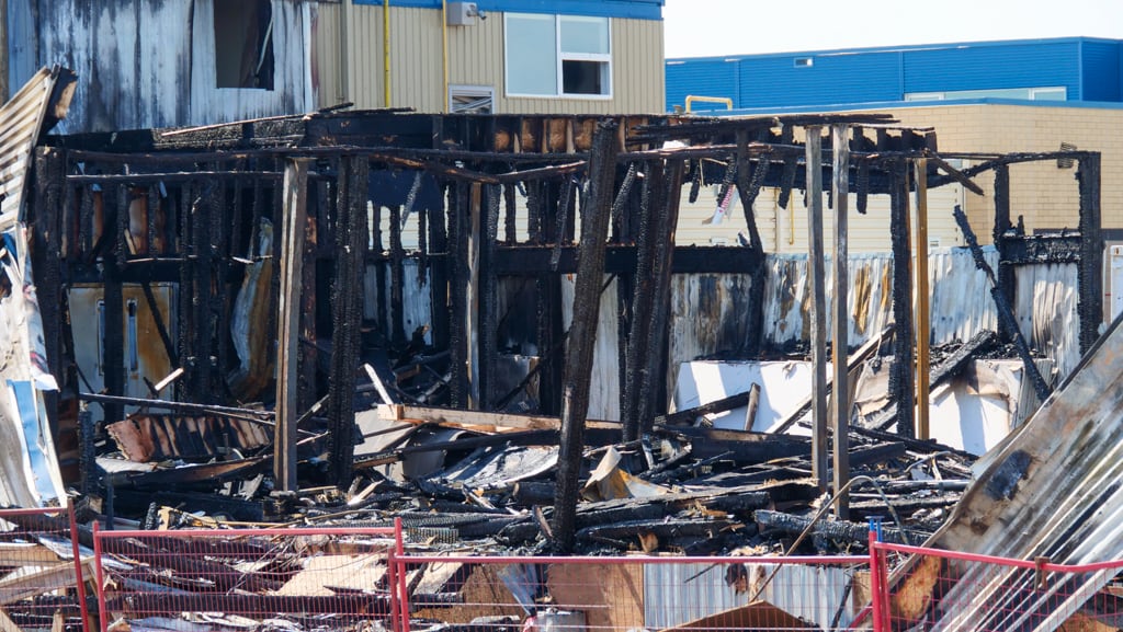 The charred remains and debris of a burned structure.