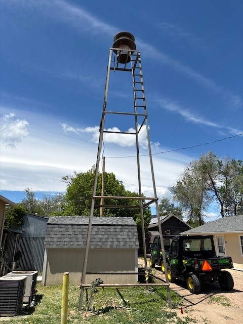 The siren tower stands behind the old Erie Town Hall building, now home to the Chamber of Commerce. The tower was removed Monday and the siren will be preserved. (Courtesy photo / town of Erie)