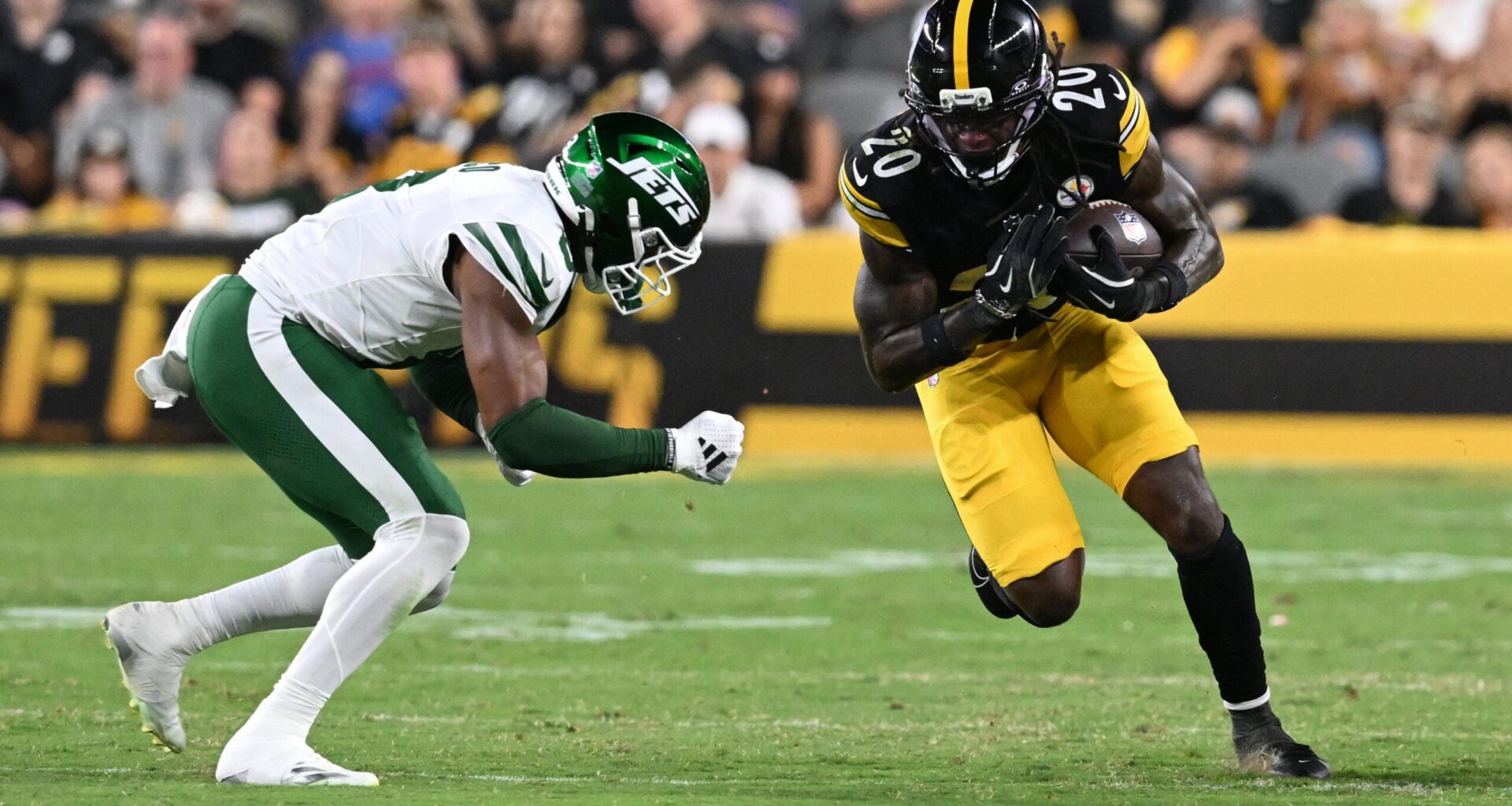 Aug 21, 2026; Pittsburgh, Pennsylvania, USA; Pittsburgh Steelers running back Kaleb Johnson (20) is tackled by New York Jets safety Andre Cisco (8) during the third quarter at Acrisure Stadium.