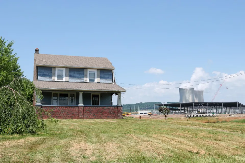 A vacant house is seen next to an Amazon Web Services (AWS)