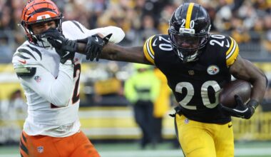 Nov 16, 2025; Pittsburgh, Pennsylvania, USA; Pittsburgh Steelers running back Kaleb Johnson (20) stiff arms Cincinnati Bengals safety Geno Stone (22) during the second half at Acrisure Stadium.