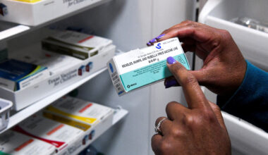 A doctor points to MMR (measles, mumps and rubella) vaccines.