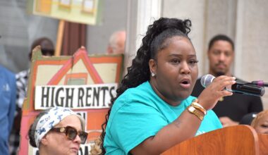Latoya Burgess, who lives in a property owned by Neighborhood Restorations, speaks at a rally Tuesday, Aug. 11, outside City Hall.