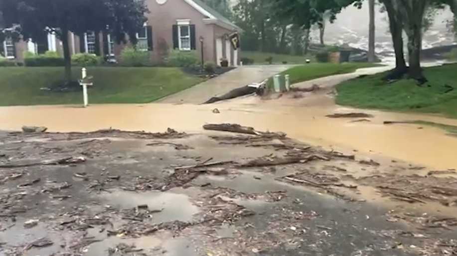 Water rushes down hillside after rain in Cranberry Township, Butler County