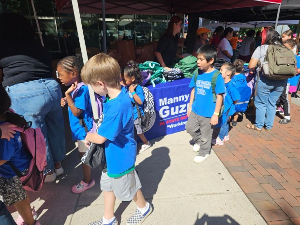 Children from the Early Beginnings Child Care Center in Reading select backpacks at the Back-to-School Giveaway, hosted by Mayor Eddie Moran and state Rep. Manny Guzman. (MICHELLE LYNCH-READING EAGLE)